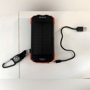 Solar powered charging bank with flashlight and charging cord.